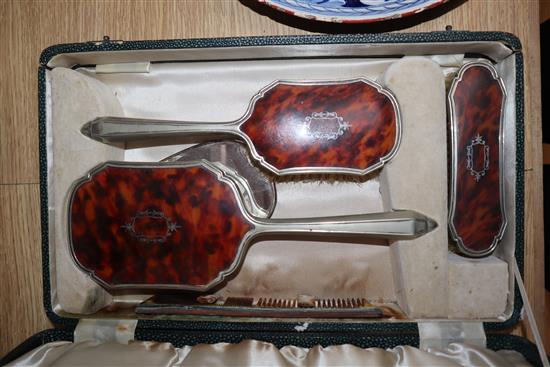 A cased plated and tortoiseshell brush set